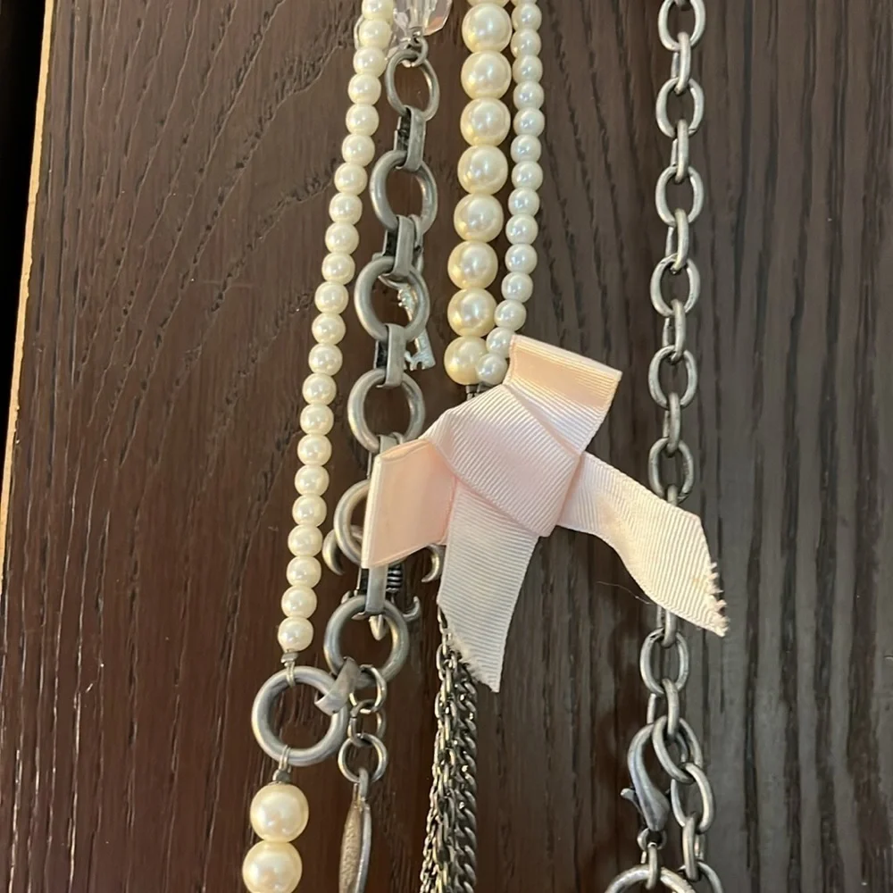 Women’s double chain belt. One of metal objects and the second chain of pearls.